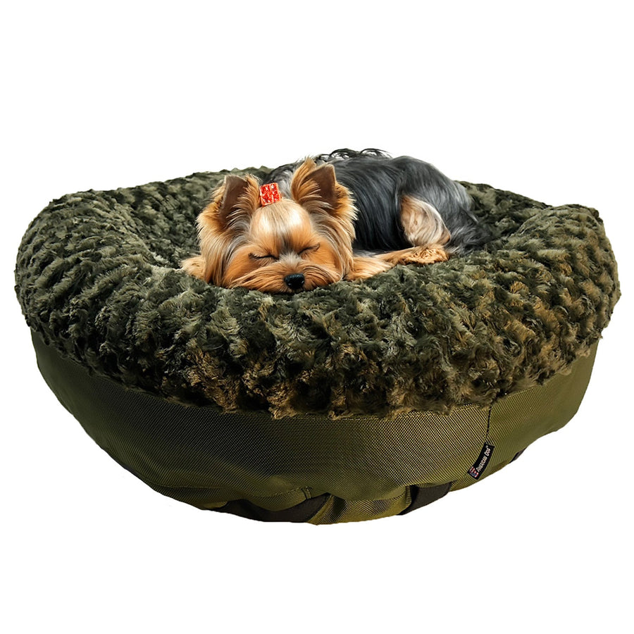 Small dog resting in an olive Furvana round bolster dog bed