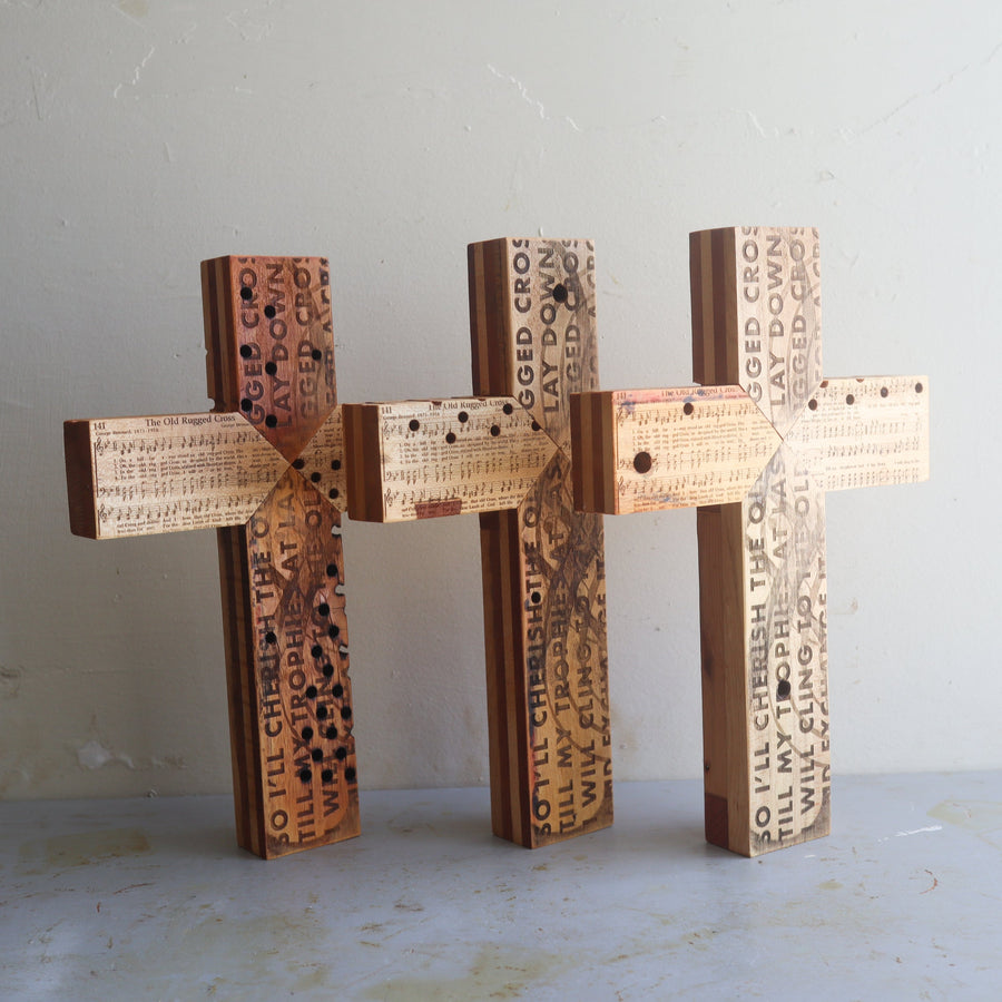 Reclaimed piano wood cross engraved with Old Rugged Cross hymn imagery.