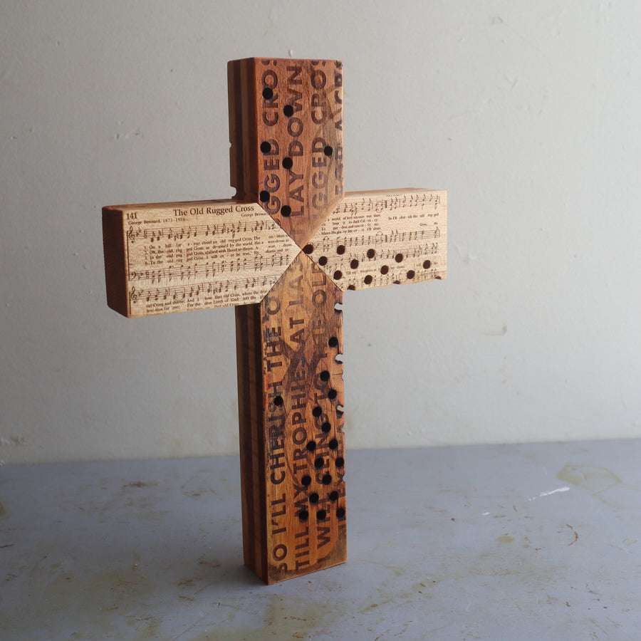 Reclaimed piano wood cross engraved with Old Rugged Cross hymn imagery.