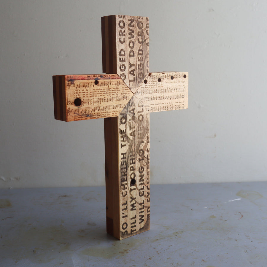 Reclaimed piano wood cross engraved with Old Rugged Cross hymn imagery.