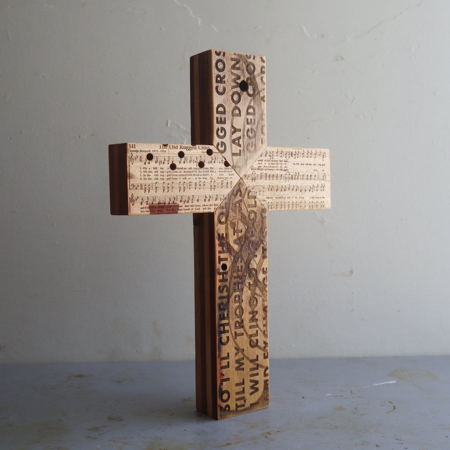 Reclaimed piano wood cross engraved with Old Rugged Cross hymn imagery.