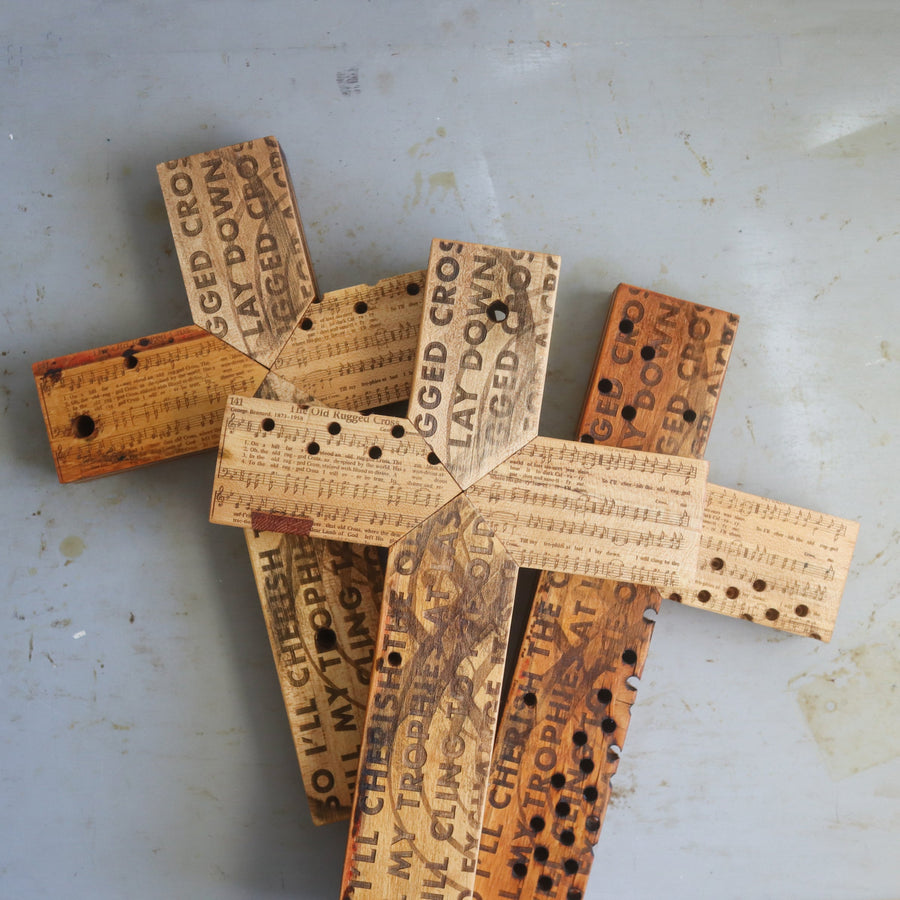 Reclaimed piano wood cross engraved with Old Rugged Cross hymn imagery.