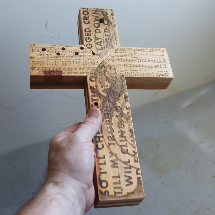 Reclaimed piano wood cross engraved with Old Rugged Cross hymn imagery.