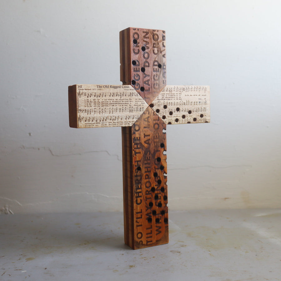 Reclaimed piano wood cross engraved with Old Rugged Cross hymn imagery.