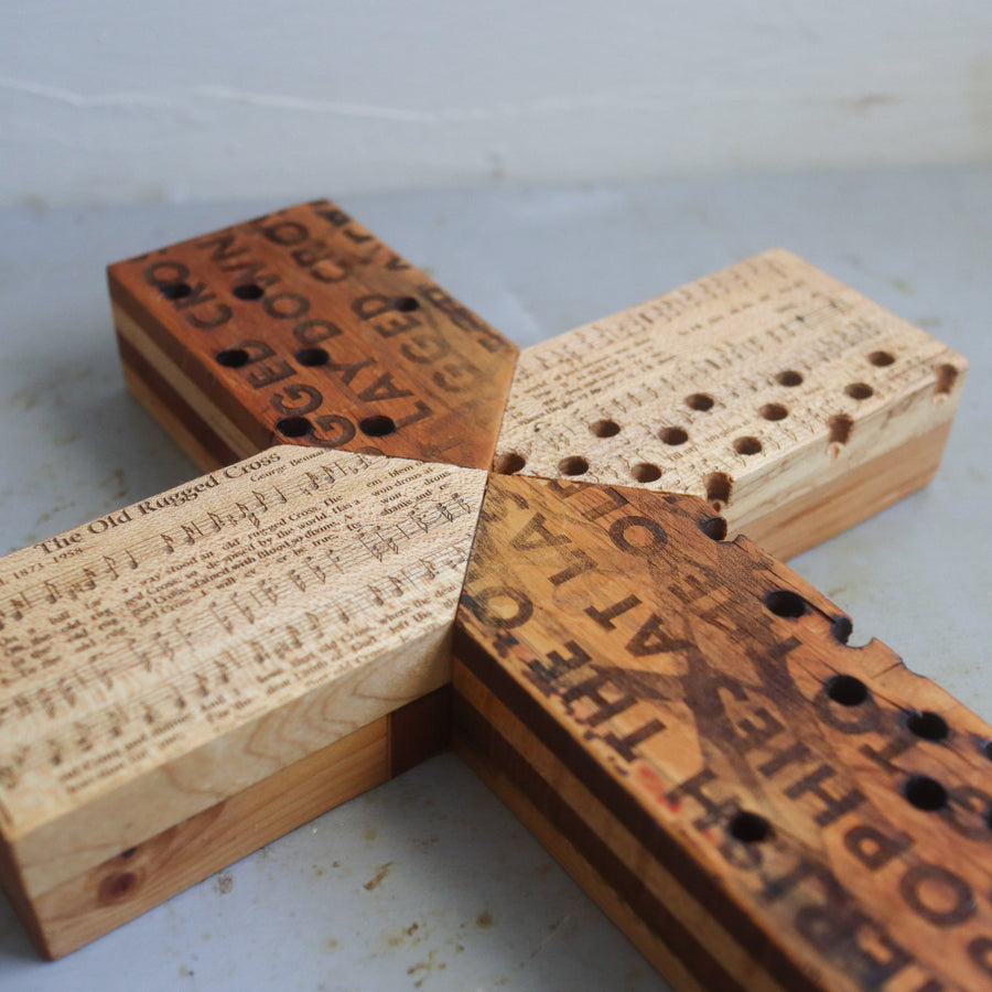 Reclaimed piano wood cross engraved with Old Rugged Cross hymn imagery.