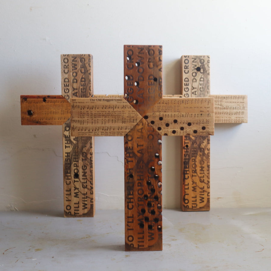 Reclaimed piano wood cross engraved with Old Rugged Cross hymn imagery.