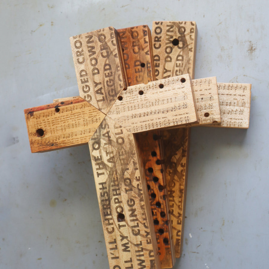 Reclaimed piano wood cross engraved with Old Rugged Cross hymn imagery.