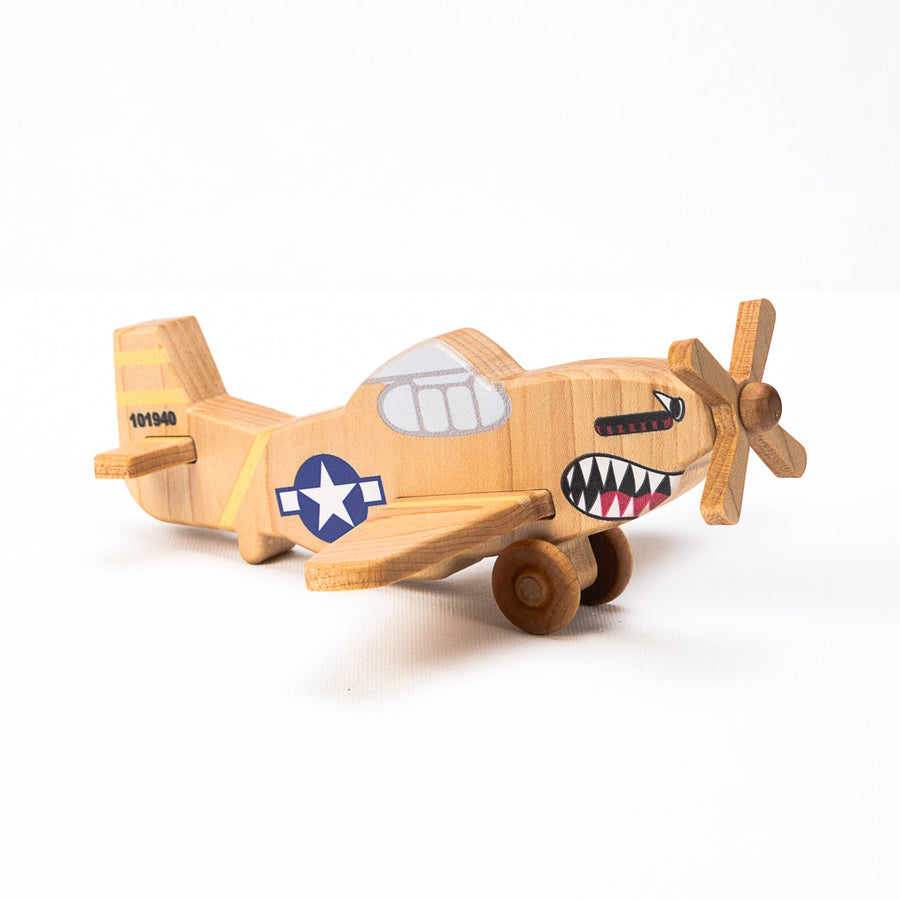 Child’s hands holding and guiding a wooden toy airplane