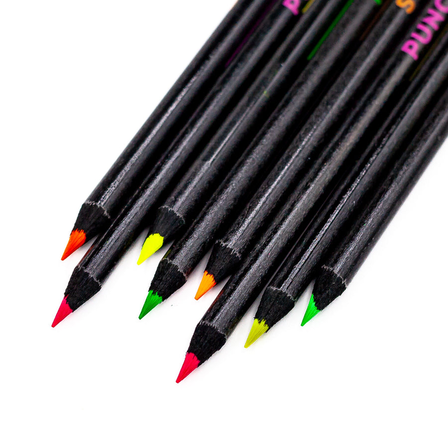 Close-up of neon highlighter pencil tips and black barrels