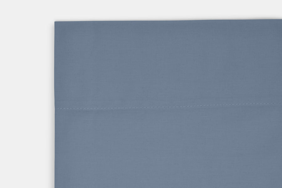 Close-up of a blue cotton sheet hem