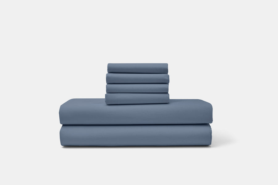Folded blue cotton percale sheets and pillowcases
