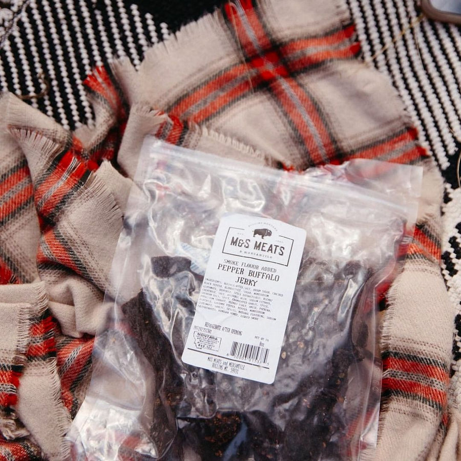 Pepper Buffalo Jerky, package resting on plaid fabric