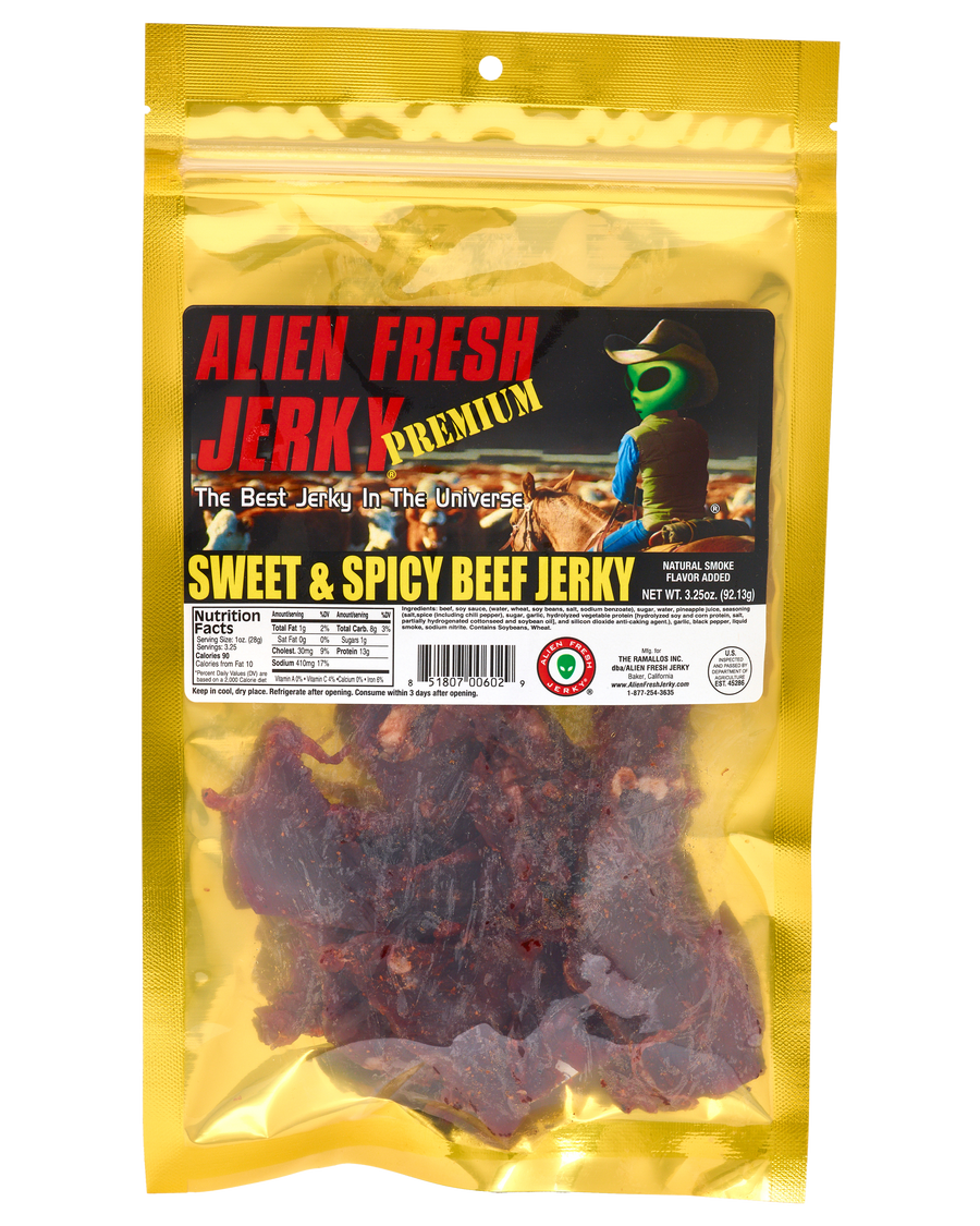Alien Fresh Jerky Sweet & Spicy beef jerky in a yellow 3.25 oz resealable bag with an alien cowboy label