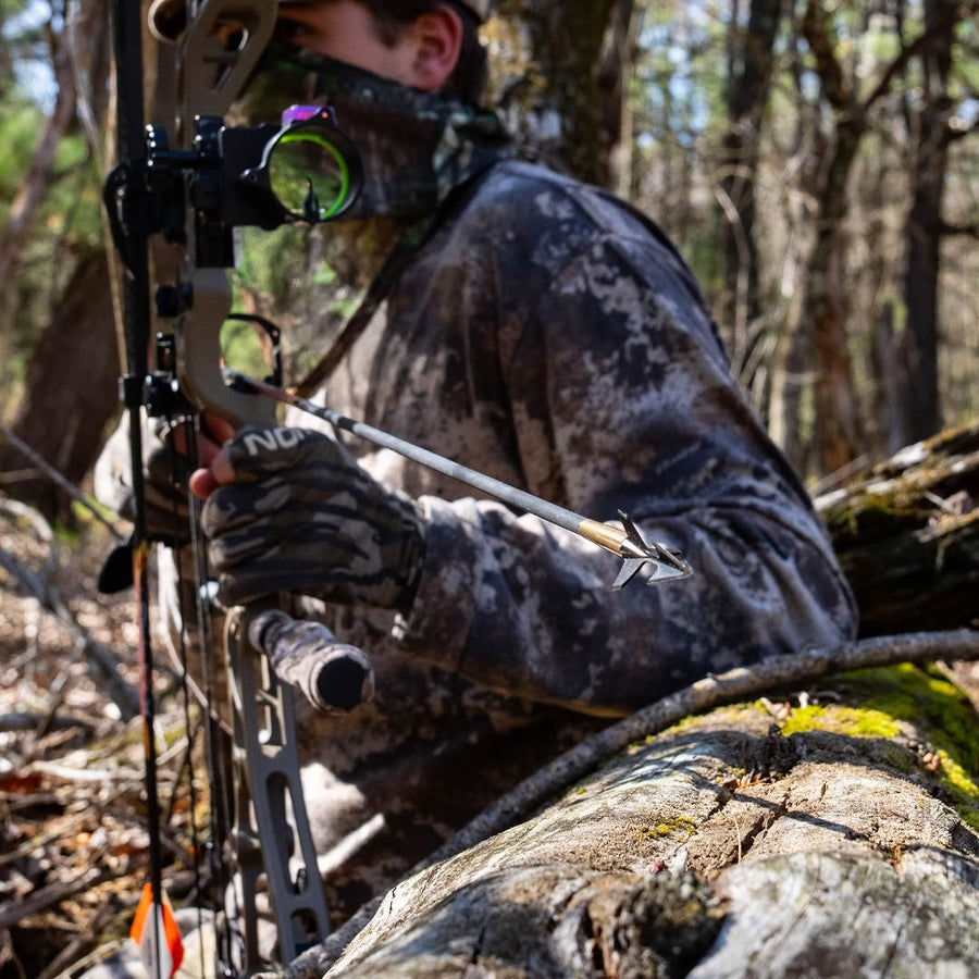 Hunter holding a bow in turkey hunting camouflage