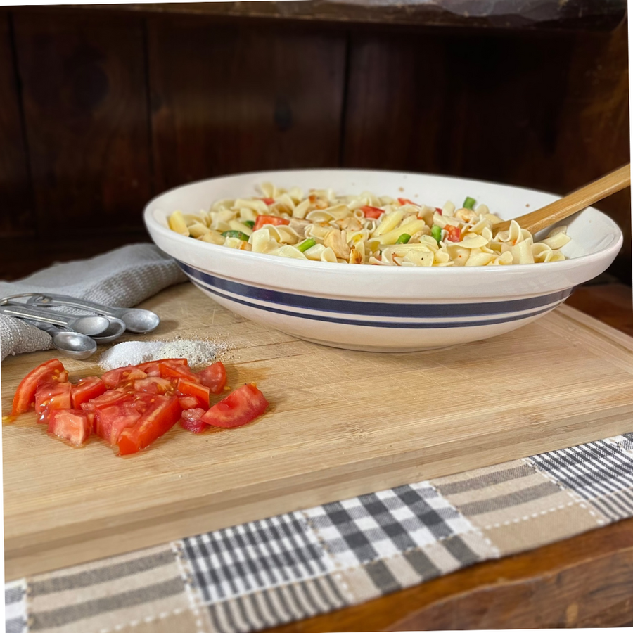Dominion pasta bowl filled with pasta on a set table