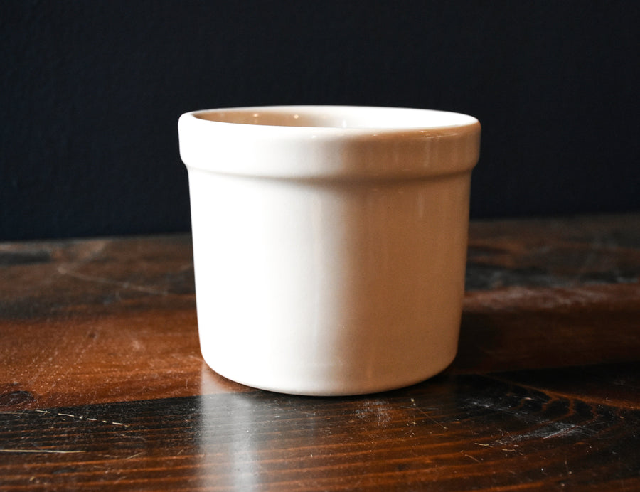 Bristol off-white stoneware utility crock - 1 pint on a wood surface