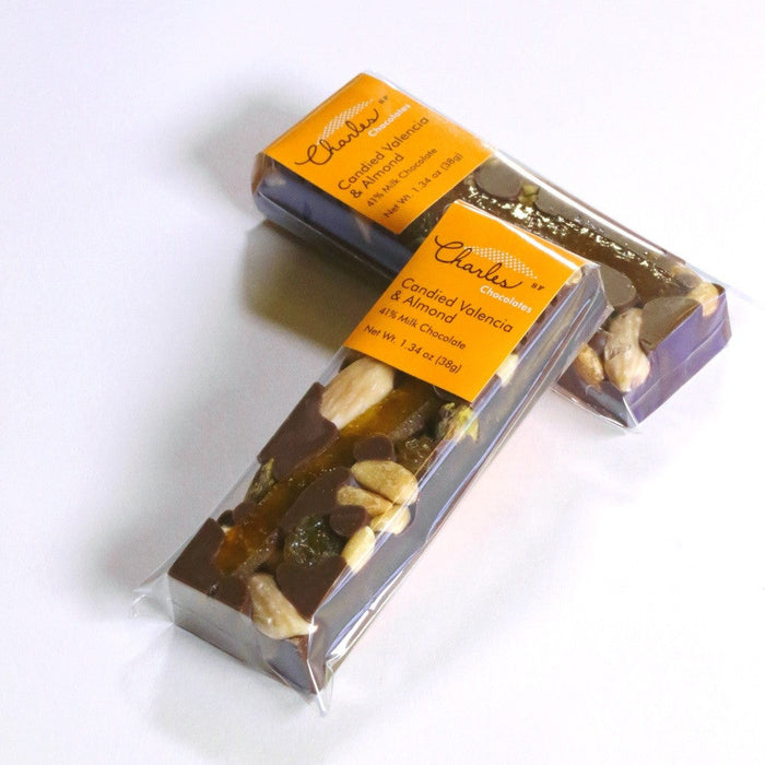 Milk chocolate Valencia orange and almond bar with opened packaging