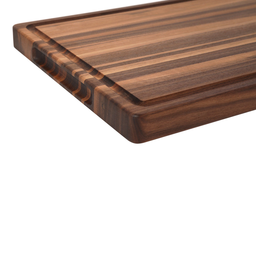 Close view of the striped edge-grain surface and thick side of a walnut board