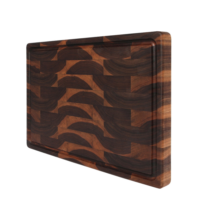 Walnut end-grain board with a juice groove standing at an angle