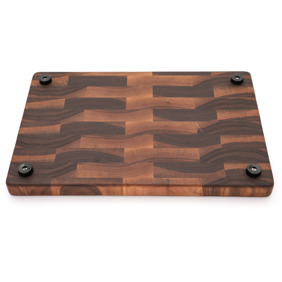 Underside of a walnut end-grain board with four rubber feet
