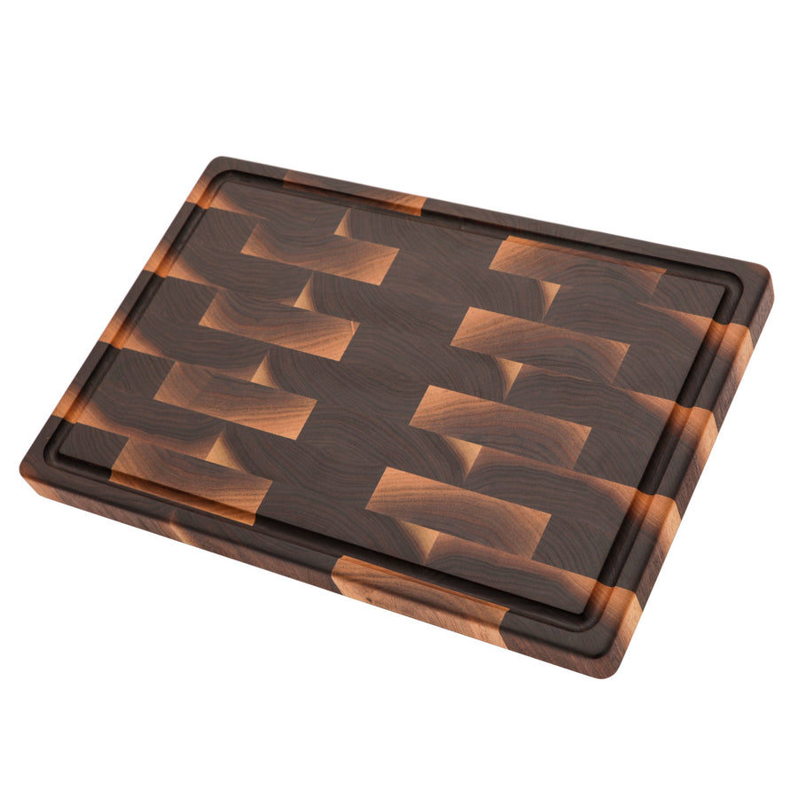 Walnut end-grain cutting board with a juice groove, angled view