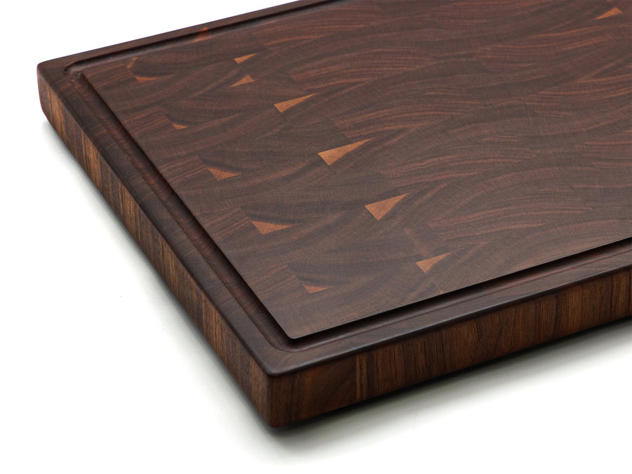 Close view of walnut end-grain blocks and a juice groove