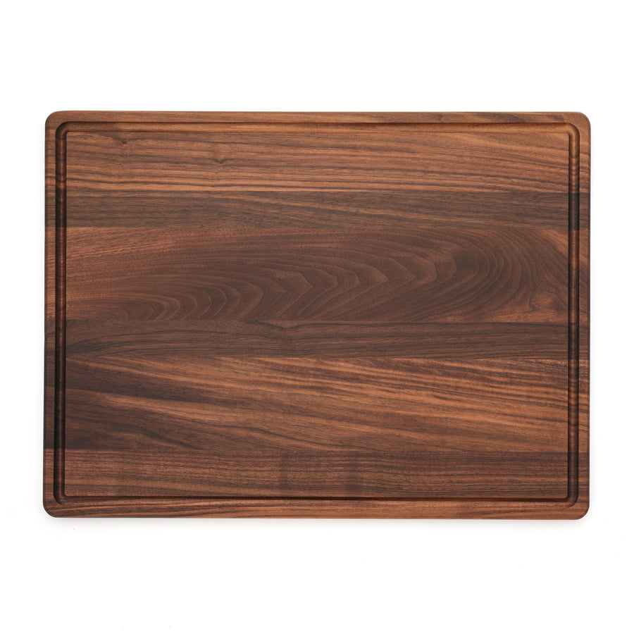 Overhead view of a large walnut board with a juice groove