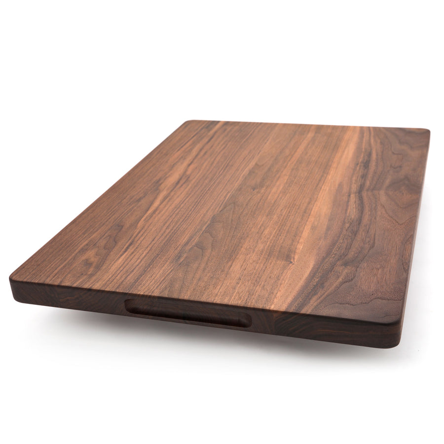 Thick walnut board showing a pocket handle beneath the edge