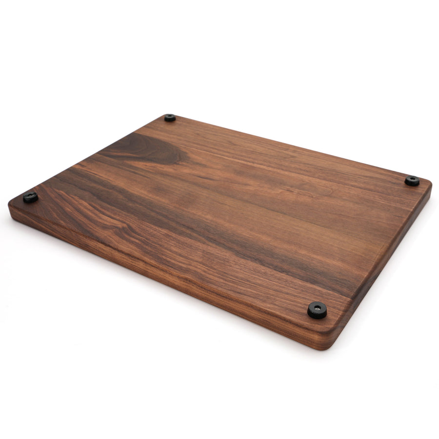 Walnut cutting board underside showing four rubber feet