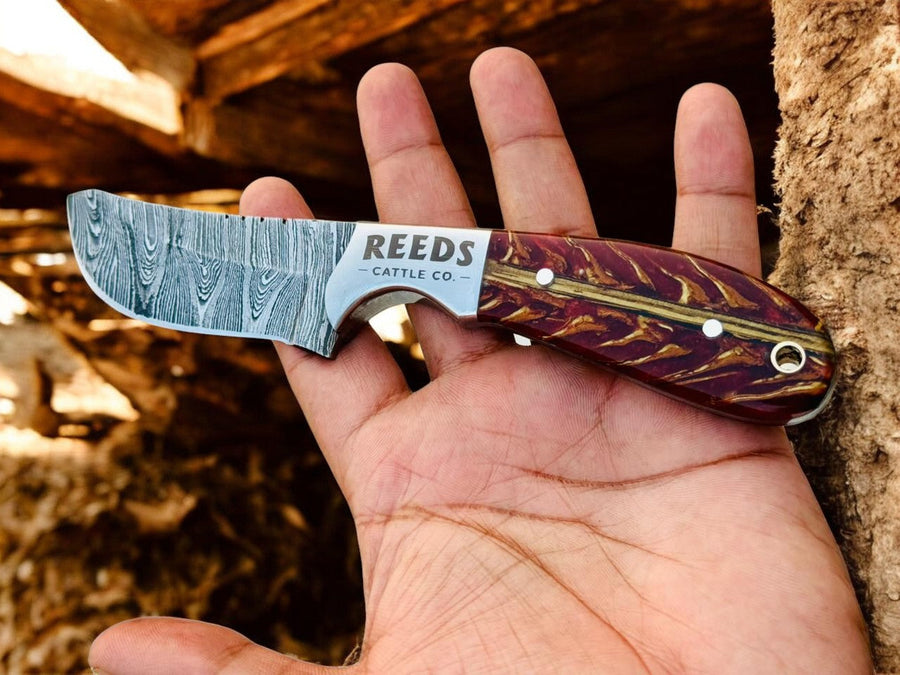 Damascus Cowboy Knife – 3.25" Blade, Red Epoxy Pine Cone Resin + Steel Bolster product photo