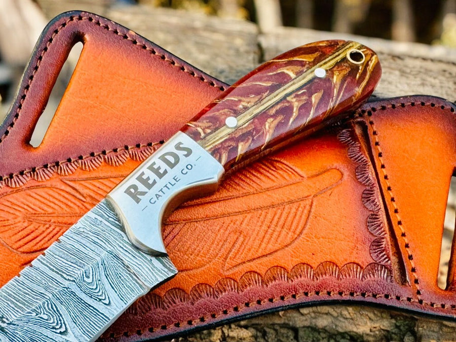 Damascus Cowboy Knife – 3.25" Blade, Red Epoxy Pine Cone Resin + Steel Bolster product photo