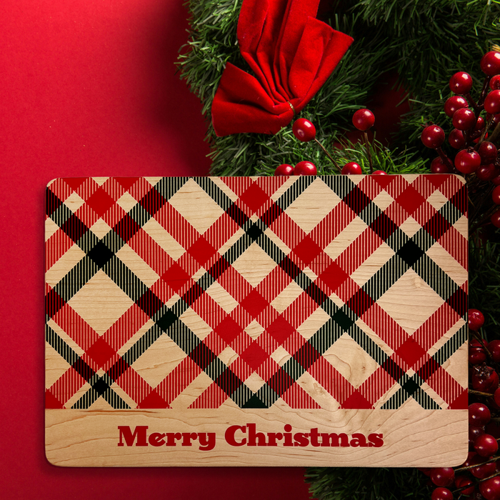 Christmas plaid maple serving board beside festive decorations