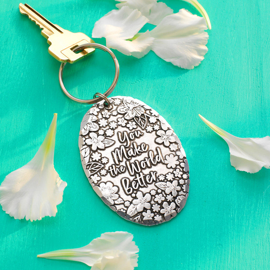 Styled display featuring You Make the World Better Keychain
