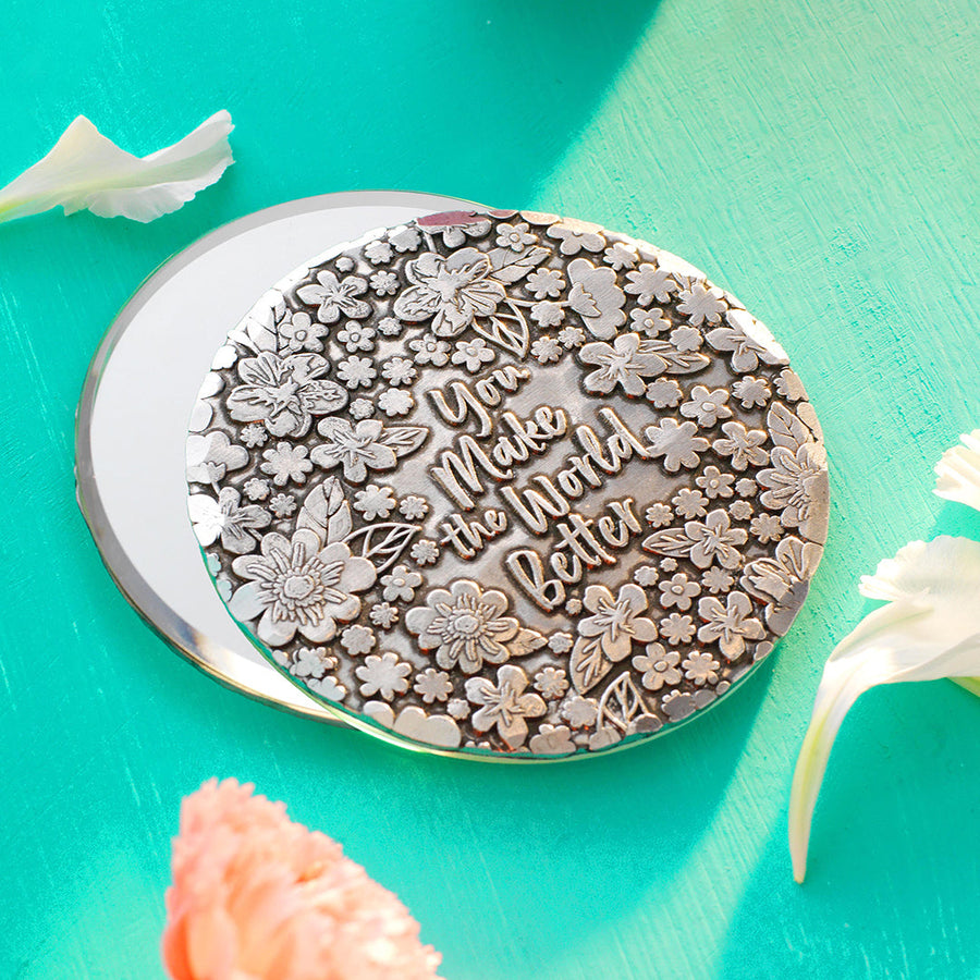 Styled display featuring You Make the World Better Hand Mirror