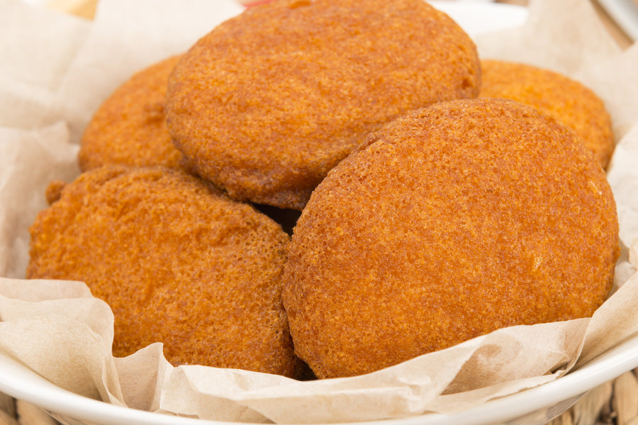 Golden fried akara bean fritters in a paper-lined bowl
