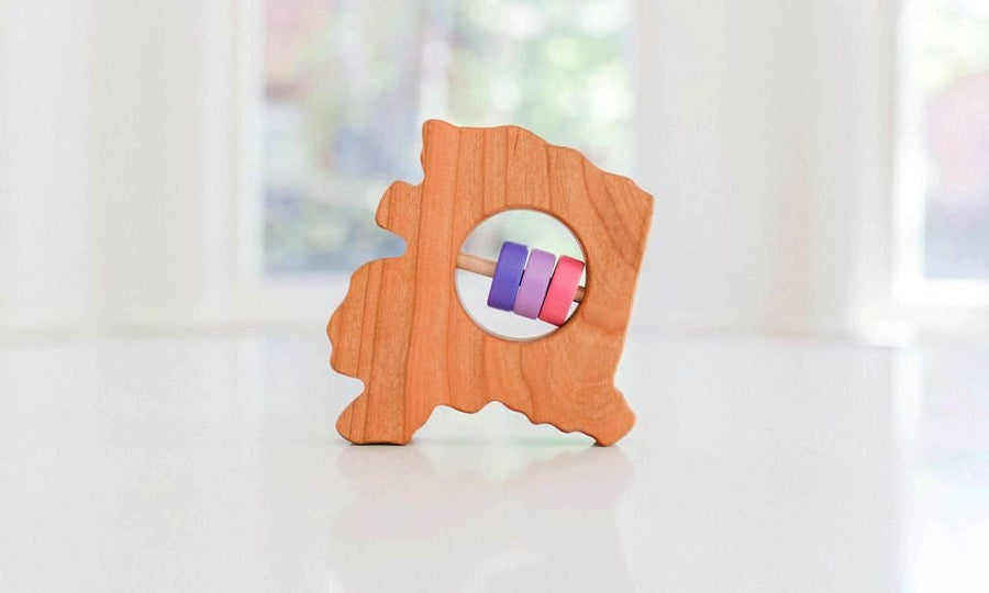 Alaska state-shaped cherry wood baby rattle with colored center disks