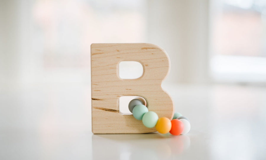 Wooden Letter Grasping Toy with Silicone Beads: letter examples