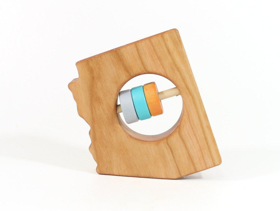 Arizona state-shaped cherry wood baby rattle with colored center disks