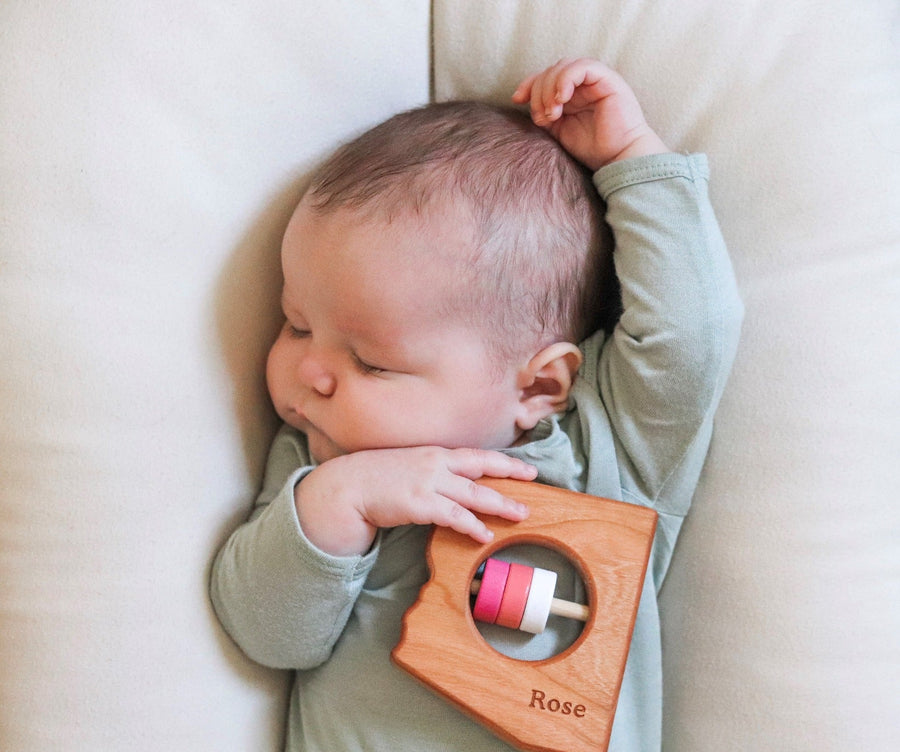 Arizona state-shaped cherry wood baby rattle with colored center disks