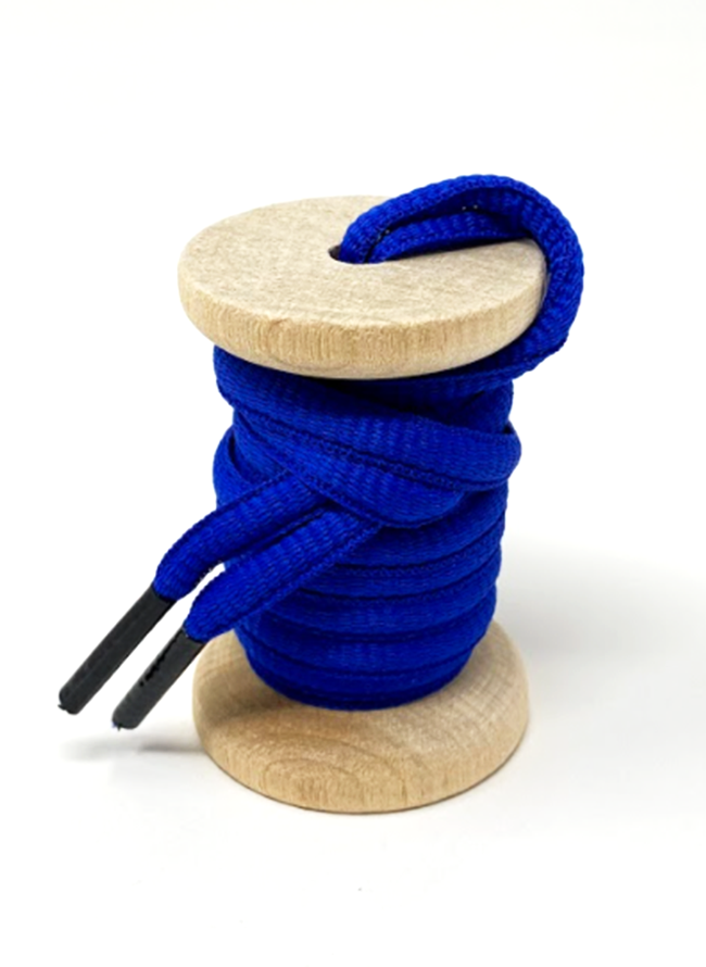 Blue oval athletic shoelaces on a wooden spool