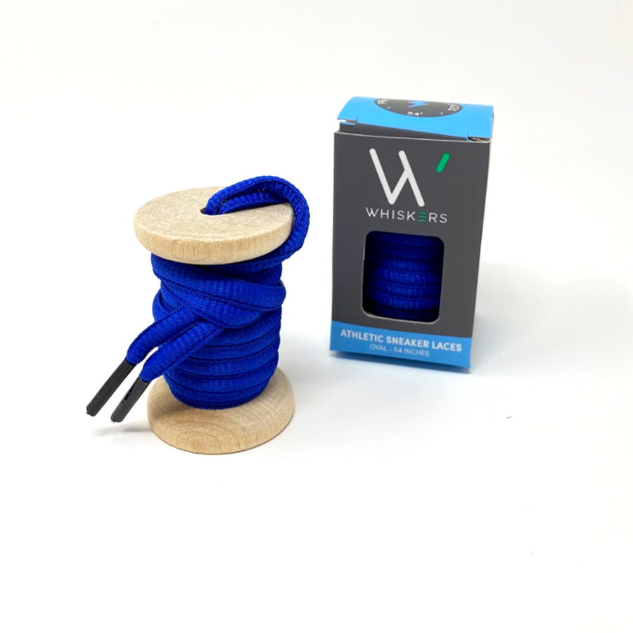 Blue oval athletic shoelaces on a wooden spool beside the retail box