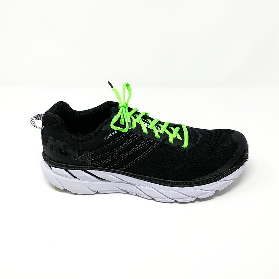 Neon Green oval athletic shoelaces laced into a black running shoe