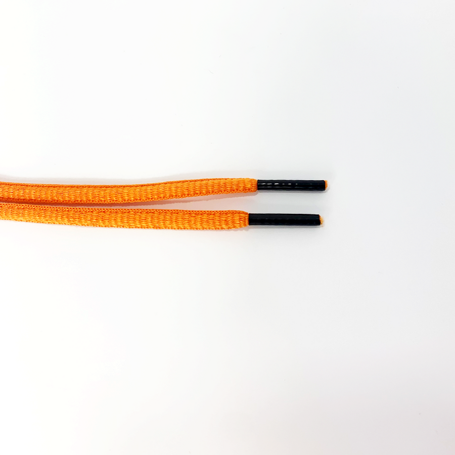 Orange oval athletic shoelaces close-up of oval lace ends and wrapped aglets