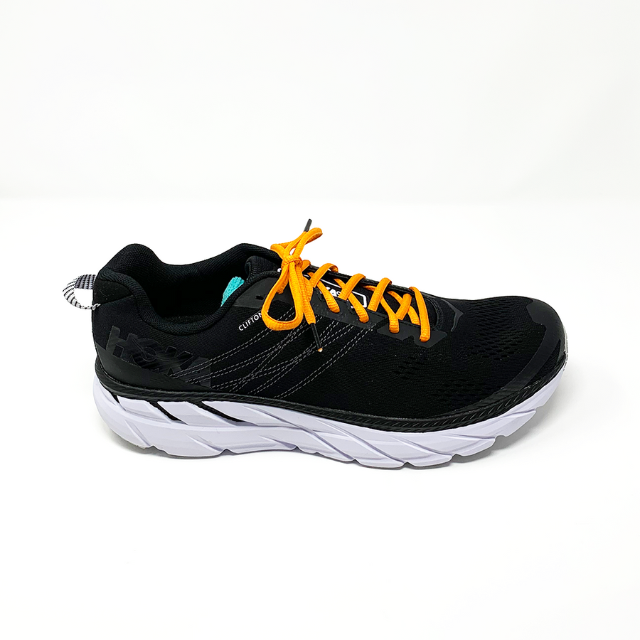 Orange oval athletic shoelaces laced into a black running shoe
