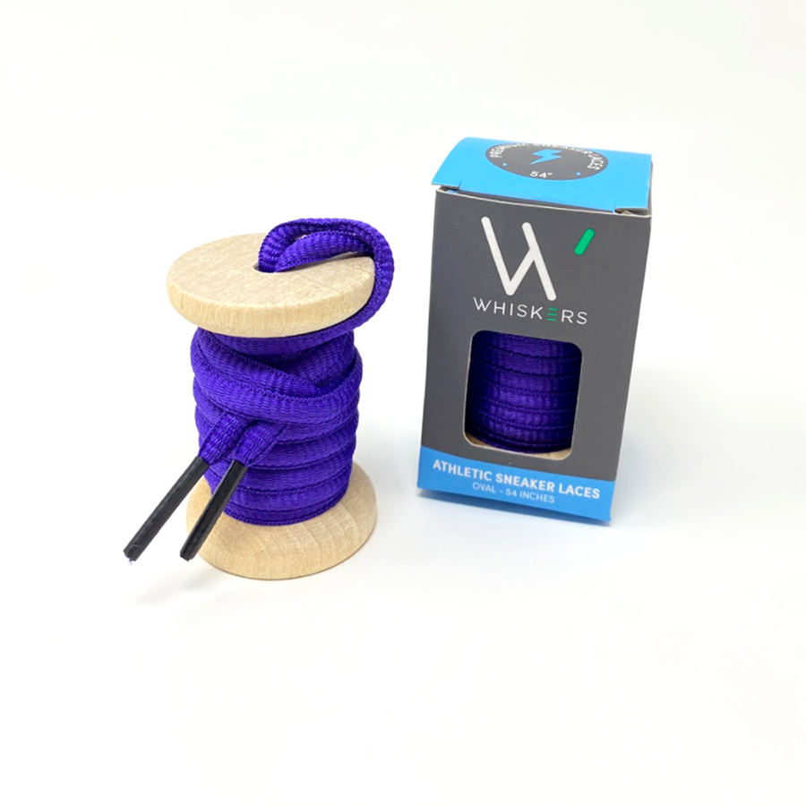 Purple oval athletic shoelaces on a wooden spool beside the retail box