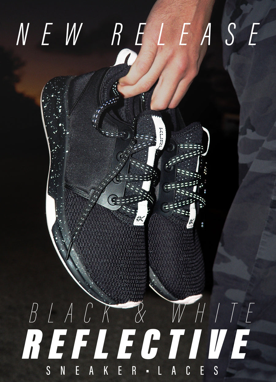 Black reflective shoelaces in a promotional photograph with reflective detail on a black running shoe