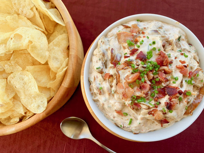 Creamy Bacon and Onion dip served beside potato chips