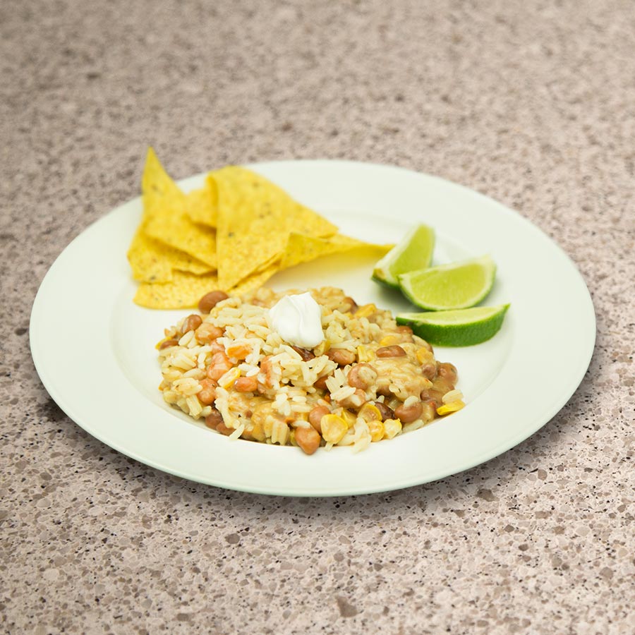 Prepared beans and rice with chips and lime, serving suggestion