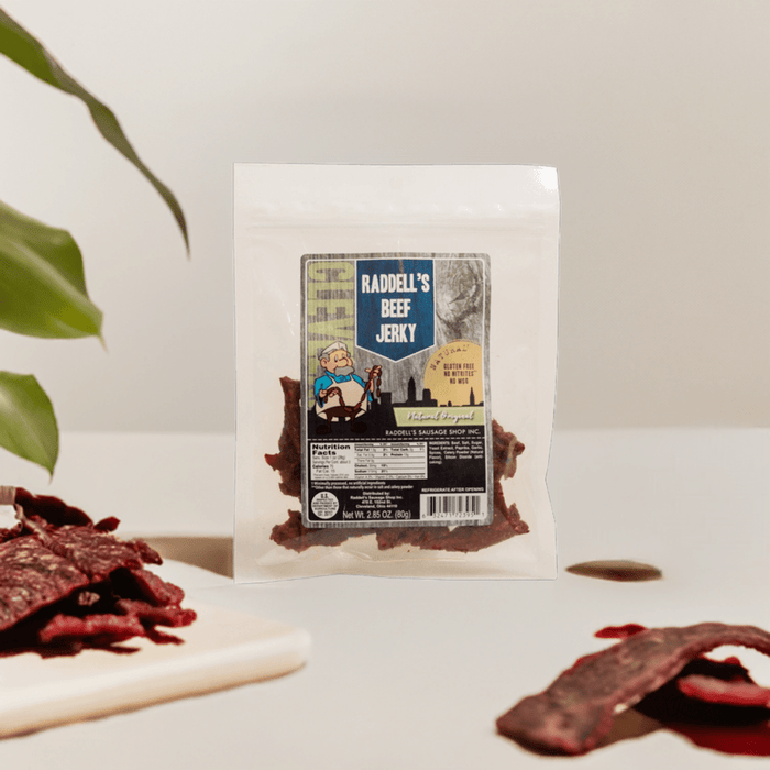 Original beef jerky bag displayed beside loose jerky pieces