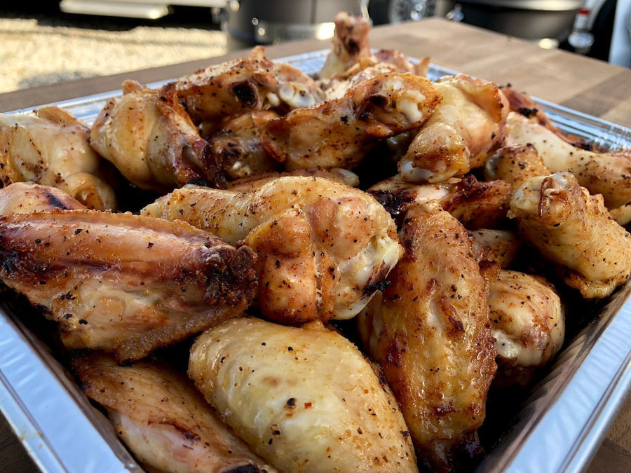 Jallelujah Jalapeño All-Purpose Seasoning: Cooked chicken drumsticks in a foil pan
